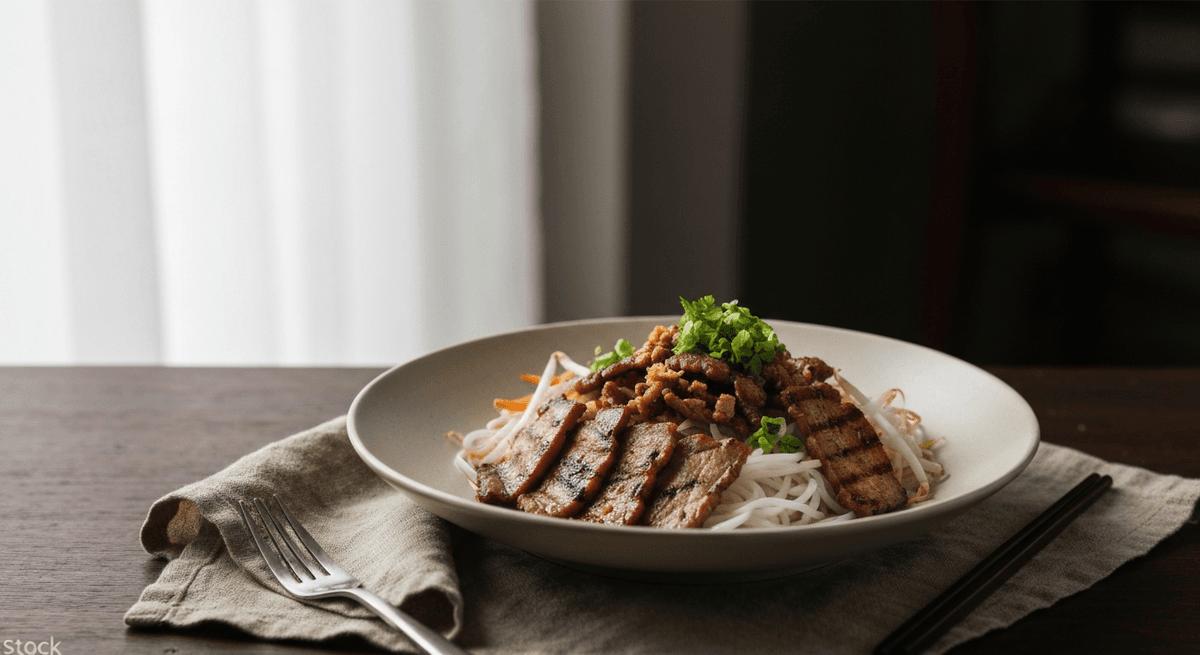Transport yourself to Hanoi with this iconic street food! Smoky grilled pork, fresh noodles, and vibrant herbs create an unforgettable flavor explosion.